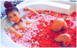 Romantic woman in bathtub with roses